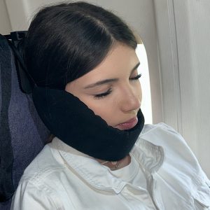 Nap-Kit travel pillow attached to airplane seat headrest using two clamps